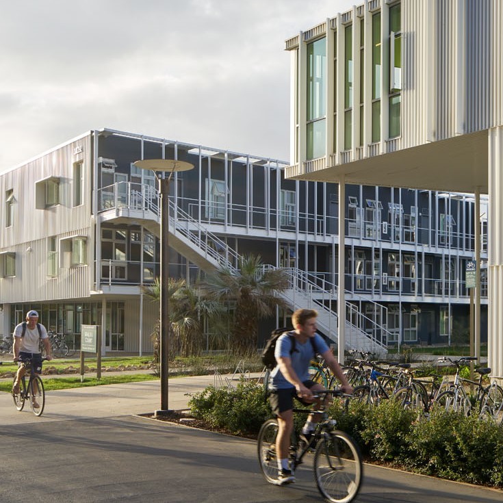 San Joaquin Village exterior with bike riders.